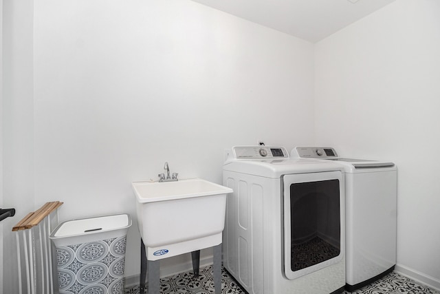 washroom with tile patterned flooring, separate washer and dryer, and sink