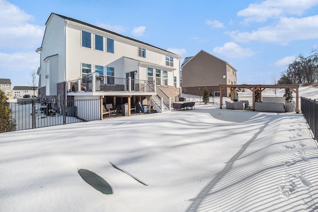 view of snow covered back of property