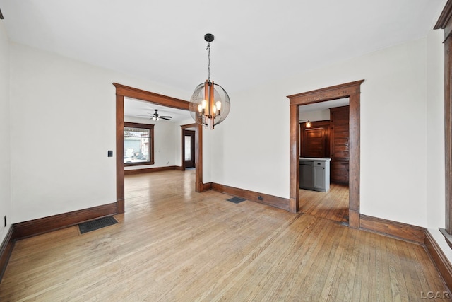 unfurnished dining area featuring light hardwood / wood-style flooring and a notable chandelier