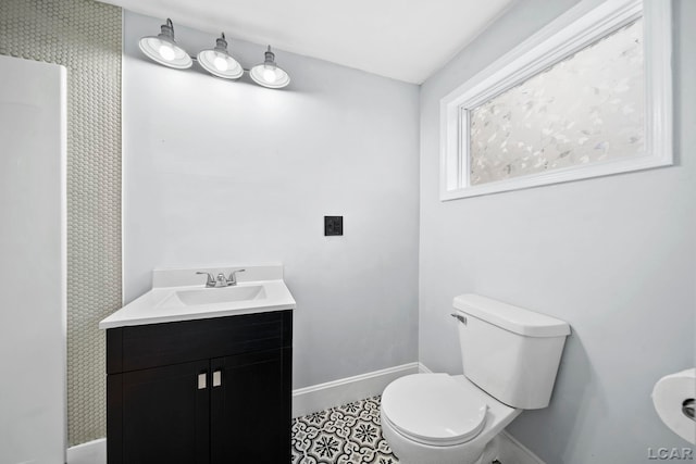 bathroom with tile patterned floors, vanity, and toilet