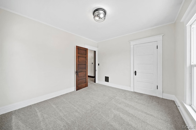 unfurnished bedroom featuring ornamental molding and carpet flooring