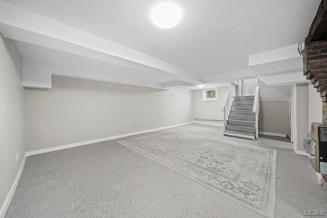 basement with heating unit and a textured ceiling