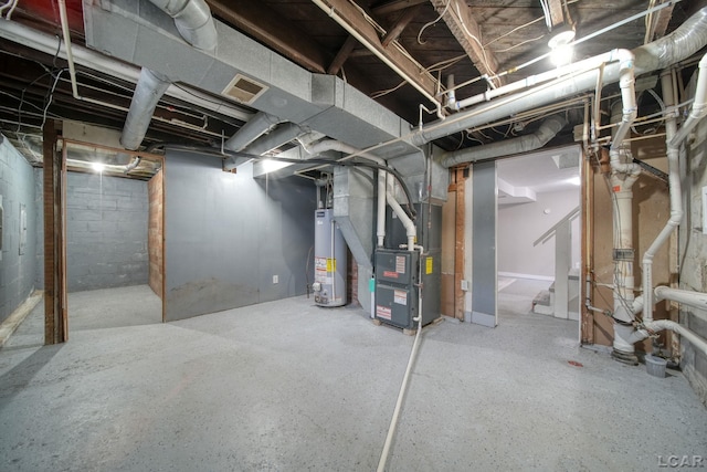 basement featuring heating unit and water heater