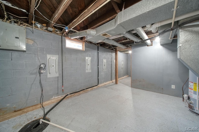 basement featuring electric panel and water heater