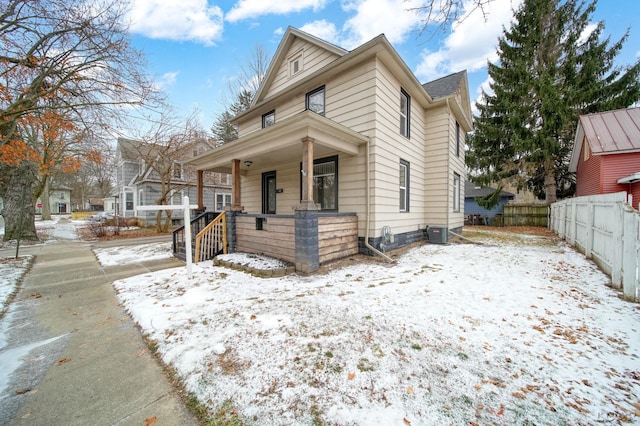 bungalow-style house featuring covered porch and central AC unit