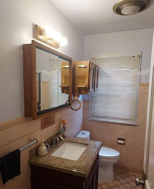 16146 Chapel St, Detroit, MI 48219 - bathroom featuring tile walls, toilet, and vanity
