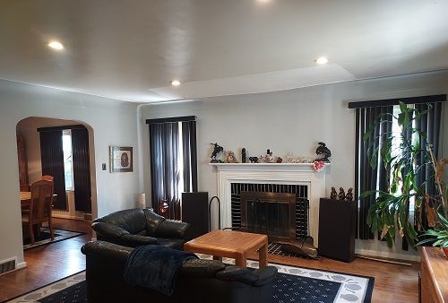 16146 Chapel St, Detroit, MI 48219 - living room with wood finished floors, arched walkways, a brick fireplace, and recessed lighting