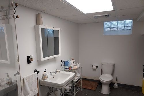 16146 Chapel St, Detroit, MI 48219 - bathroom featuring toilet, tile patterned flooring, a sink, and a drop ceiling