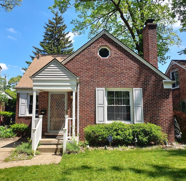16146 Chapel St, Detroit, MI 48219 - bungalow-style house featuring a chimney, brick siding, and a front lawn