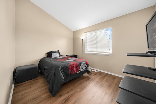 bedroom featuring hardwood / wood-style flooring and lofted ceiling