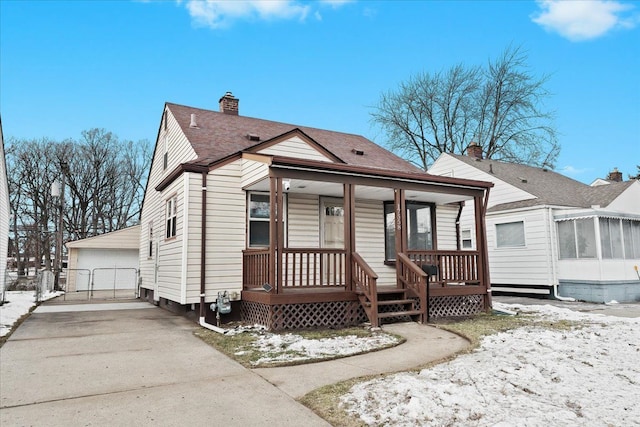 view of front facade featuring an outdoor structure, a porch, and a garage