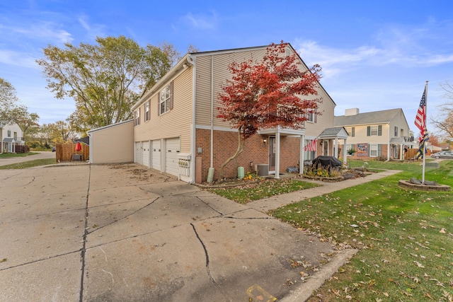 view of side of home with a lawn and a garage