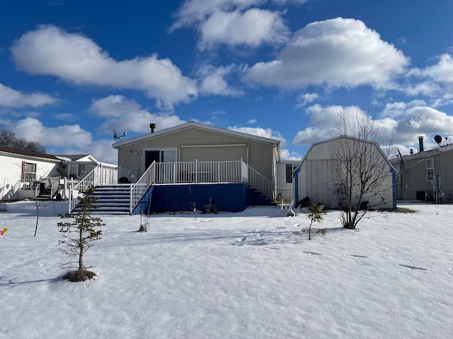 view of snow covered back of property