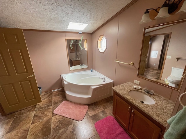 bathroom featuring crown molding, a skylight, vanity, a bath, and a textured ceiling