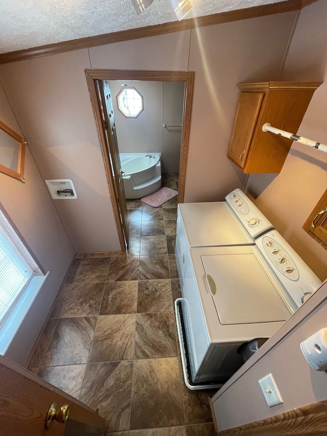 772 Hawick Cir, Mount Morris, MI 48458 - laundry room with washing machine and clothes dryer, dark stone finish floors, and crown molding