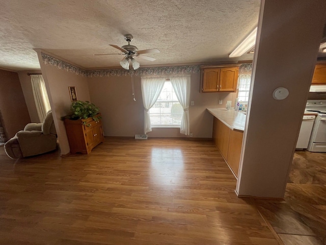 772 Hawick Cir, Mount Morris, MI 48458 - kitchen with white electric range, a textured ceiling, a ceiling fan, light wood finished floors, and light countertops