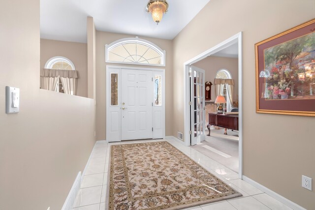 310 Sycamore St, Litchfield, MI 49252 - entrance foyer featuring light tile patterned floors, plenty of natural light, baseboards, and visible vents