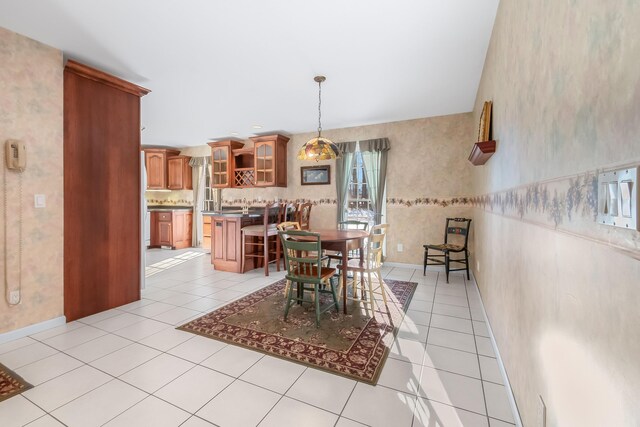 310 Sycamore St, Litchfield, MI 49252 - dining space featuring light tile patterned floors, baseboards, and wallpapered walls
