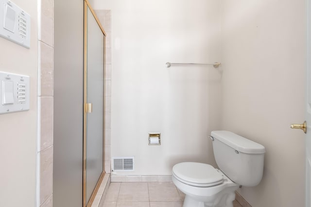310 Sycamore St, Litchfield, MI 49252 - bathroom featuring a stall shower, toilet, tile patterned flooring, baseboards, and visible vents