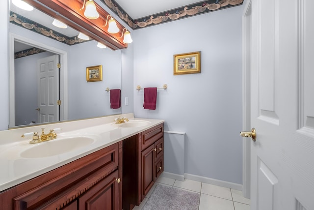 310 Sycamore St, Litchfield, MI 49252 - bathroom featuring double vanity, tile patterned flooring, a sink, and baseboards