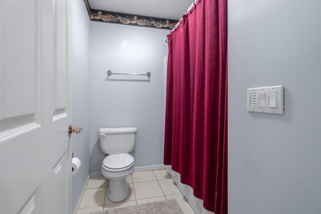 310 Sycamore St, Litchfield, MI 49252 - full bathroom featuring baseboards, toilet, tile patterned flooring, and curtained shower