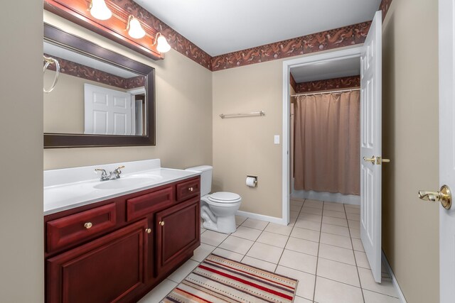 310 Sycamore St, Litchfield, MI 49252 - bathroom with a shower with shower curtain, baseboards, toilet, vanity, and tile patterned flooring
