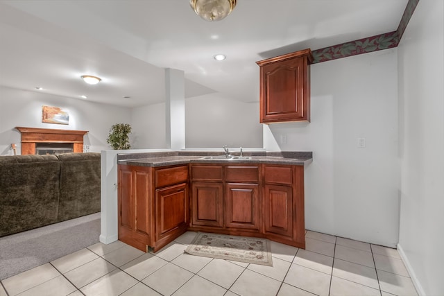 310 Sycamore St, Litchfield, MI 49252 - kitchen featuring open floor plan, dark countertops, a sink, and light tile patterned floors