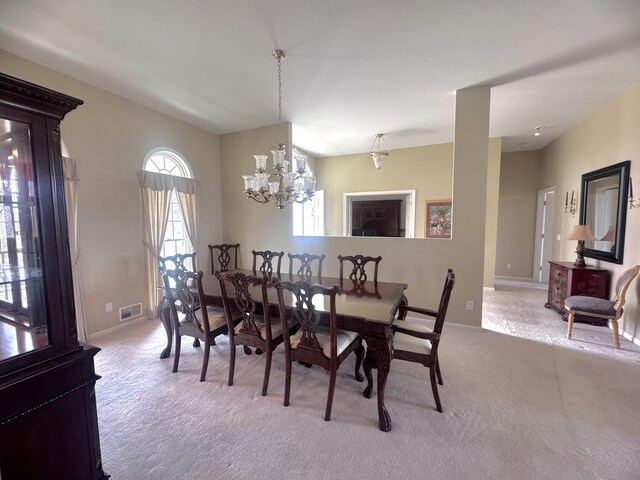 310 Sycamore St, Litchfield, MI 49252 - dining space featuring light carpet, baseboards, visible vents, and a chandelier