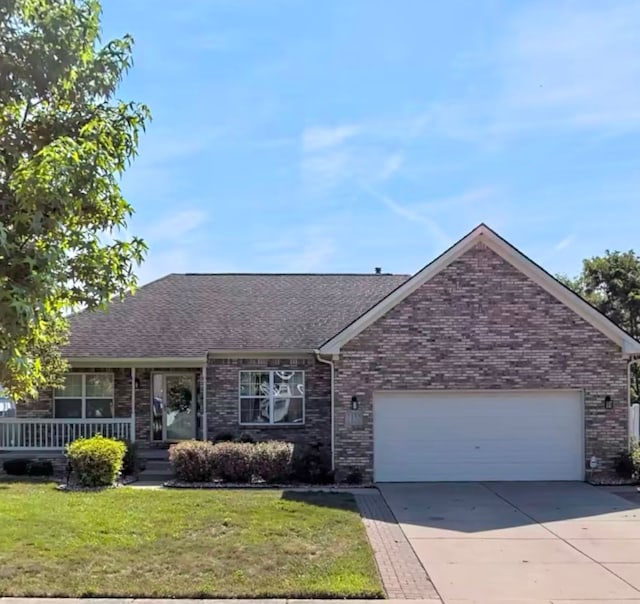 ranch-style home featuring a garage, a front yard, and covered porch