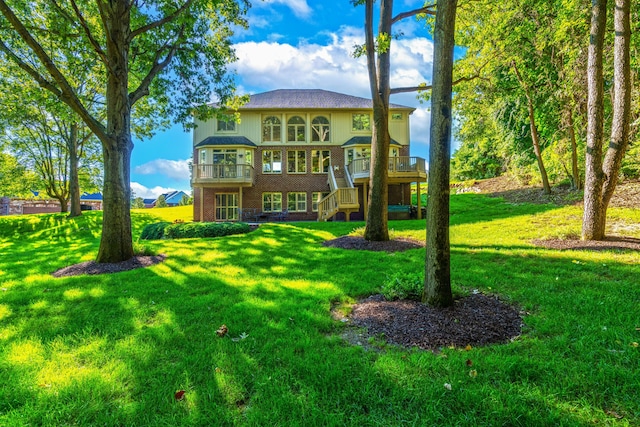 back of property featuring a wooden deck and a yard