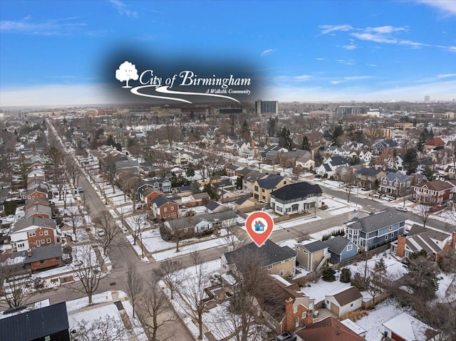 snowy aerial view featuring a residential view