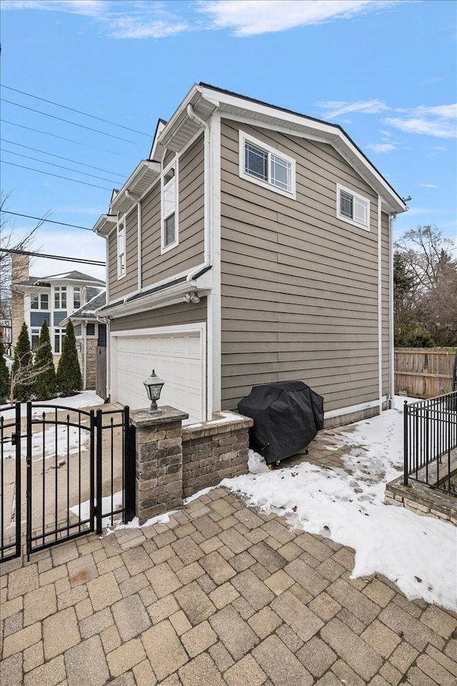 view of home's exterior featuring fence and an attached garage