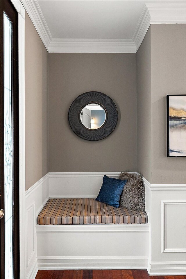 mudroom with a wainscoted wall and ornamental molding