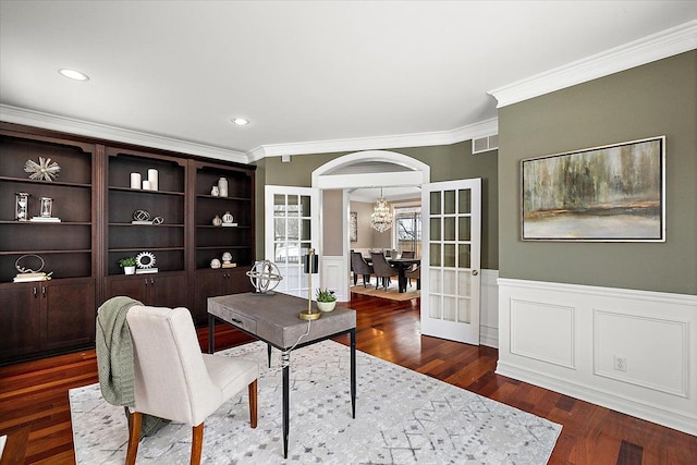 office area featuring a wainscoted wall, wood finished floors, visible vents, french doors, and crown molding