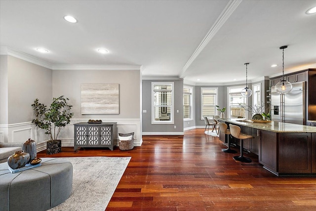 living room with recessed lighting, dark wood-style flooring, wainscoting, and crown molding