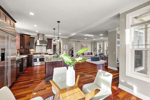 dining space featuring dark wood finished floors, crown molding, baseboards, and recessed lighting