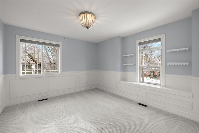 1419 Henrietta St, Birmingham, MI 48009 - carpeted spare room featuring plenty of natural light, wainscoting, and visible vents