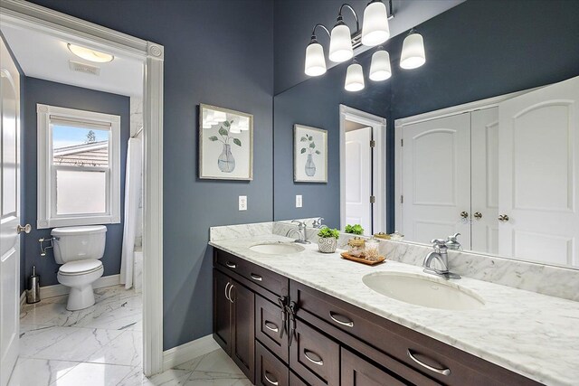 bathroom with marble finish floor, baseboards, a sink, and toilet