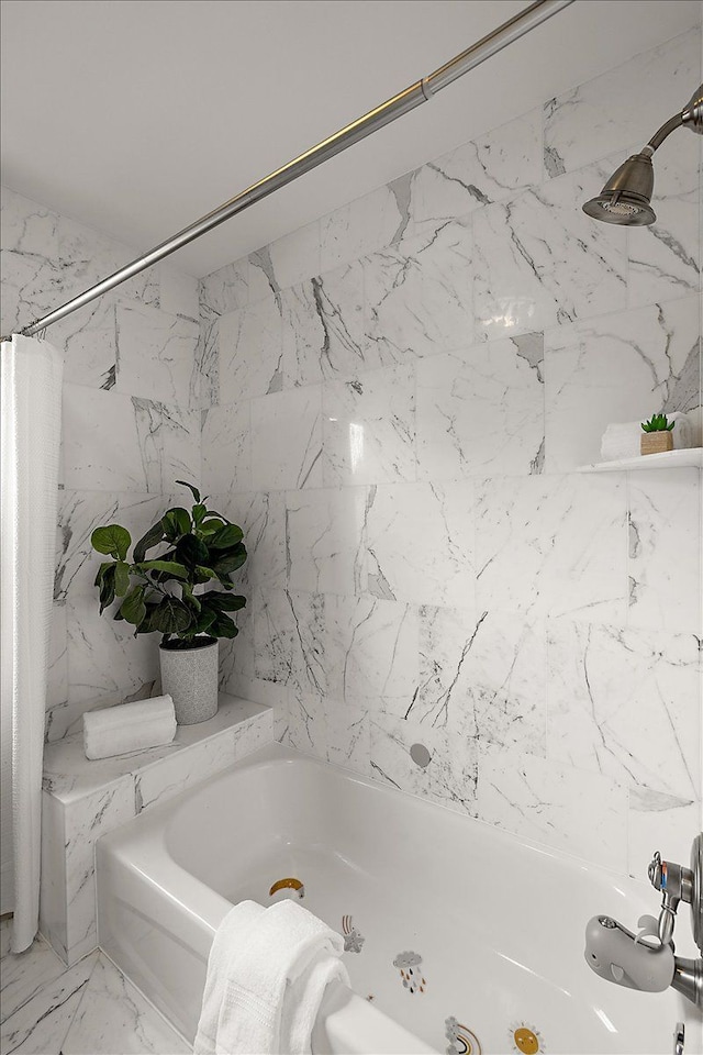 full bathroom with stone wall