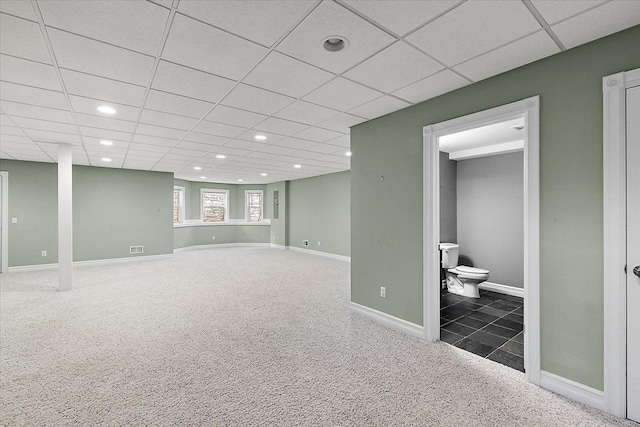 below grade area with carpet floors, recessed lighting, a paneled ceiling, visible vents, and baseboards