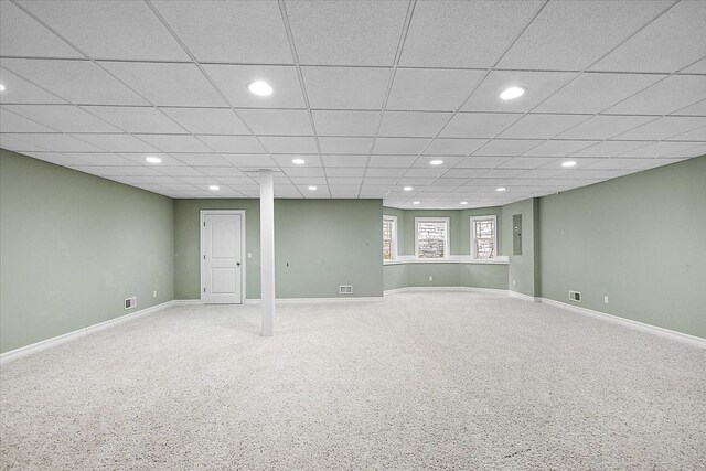 below grade area with carpet floors, baseboards, a drop ceiling, and recessed lighting