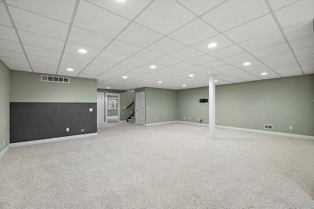 finished below grade area featuring baseboards, stairs, visible vents, and recessed lighting