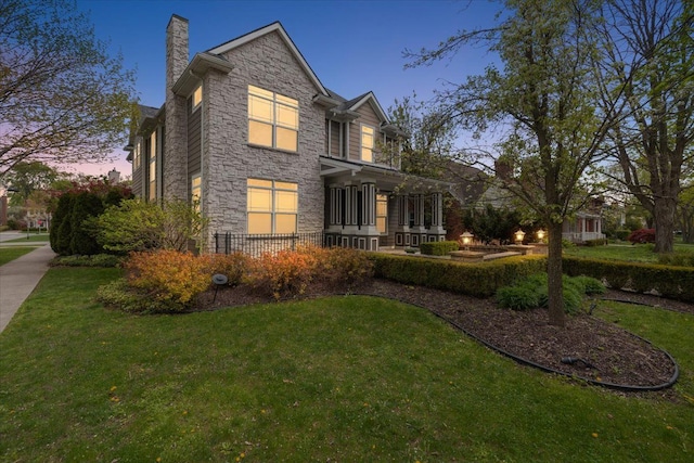 1419 Henrietta St, Birmingham, MI 48009 - view of front facade featuring a chimney, stone siding, and a front lawn