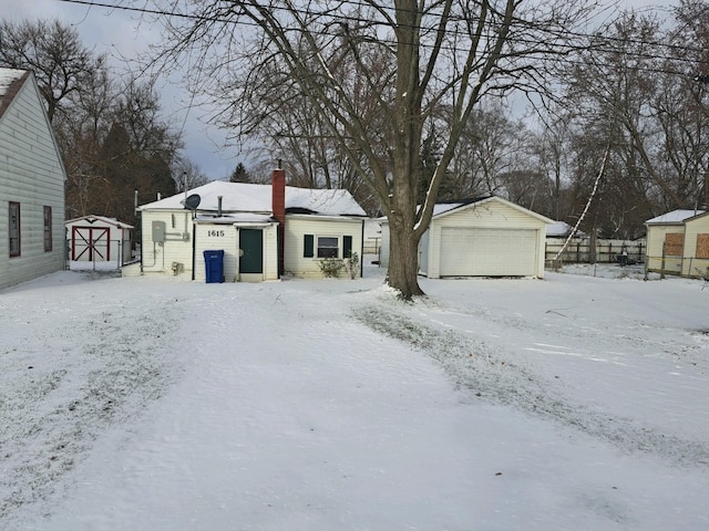 view of front of house with a garage and a storage unit