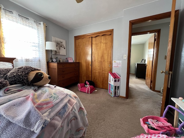 bedroom featuring light carpet and a closet