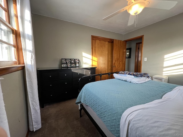 bedroom featuring ceiling fan and dark colored carpet