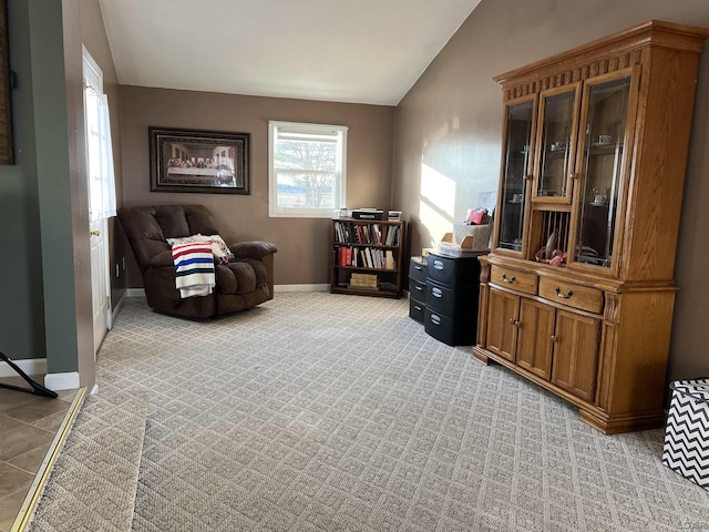 sitting room featuring lofted ceiling, plenty of natural light, and light colored carpet