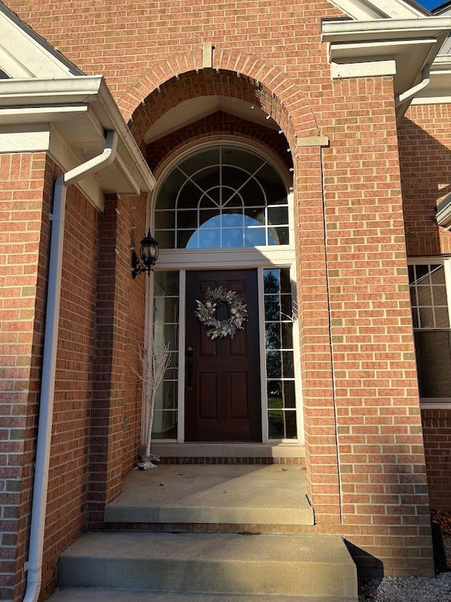 property entrance featuring brick siding