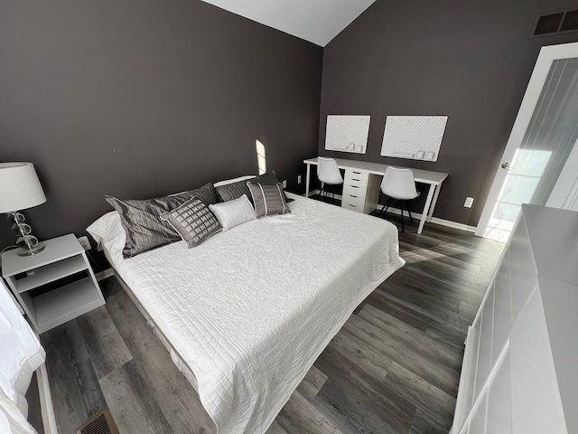 bedroom featuring vaulted ceiling, visible vents, dark wood finished floors, and baseboards