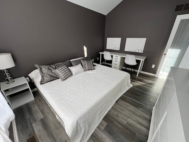 119 Prestwick Trl, Highland, MI 48357 - bedroom featuring lofted ceiling, baseboards, visible vents, and dark wood-style floors